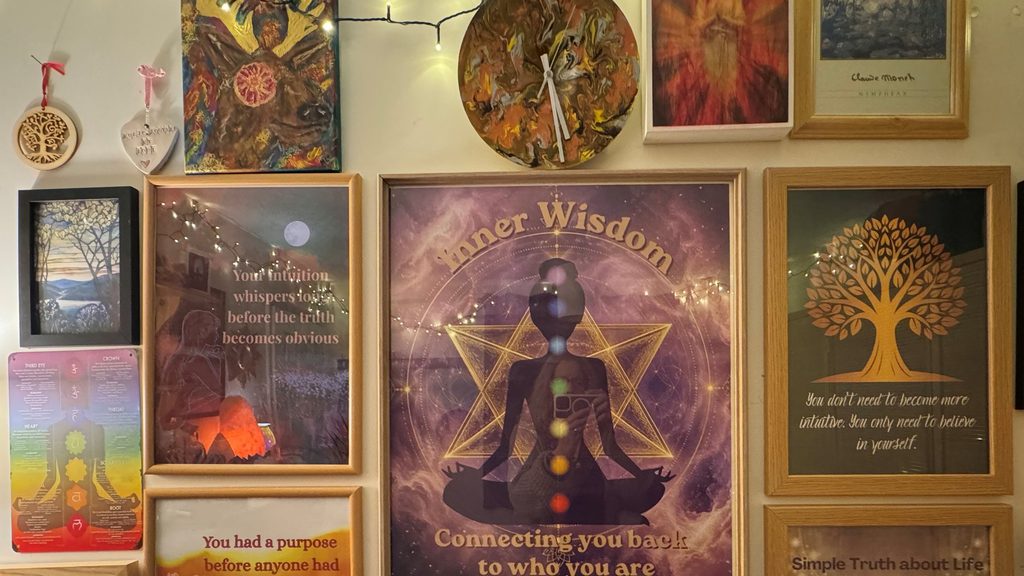 The wall of framed posters and affirmations in my healing room, including the Inner Wisdom poster.